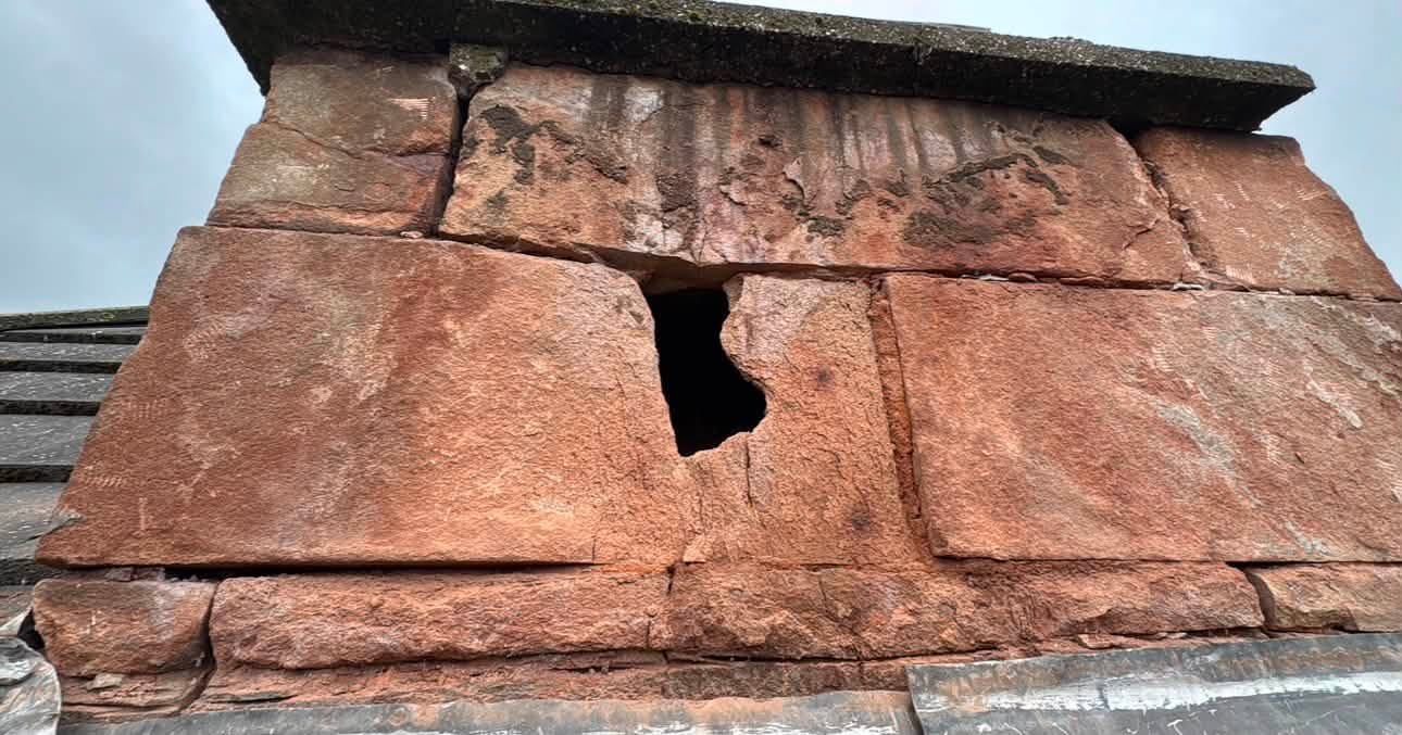 Chimney head with a hole through eroded sandstone before restoration